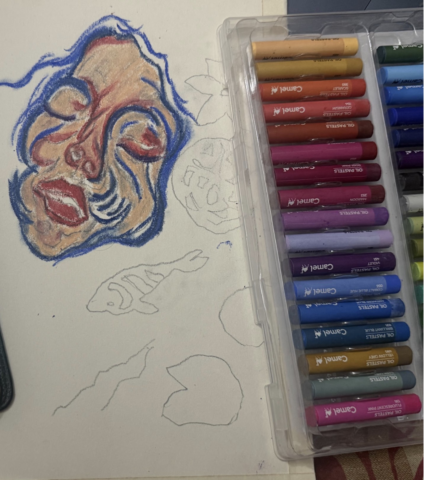The face after the first smudge, its colors softened, with the rest of the page still in pencil