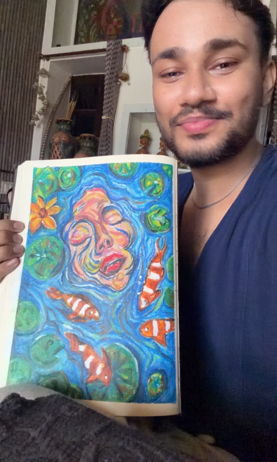Holding the finished sketchbook page up to the camera at home, the painting facing out
